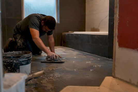 Contractor applying tile grout in bathroom