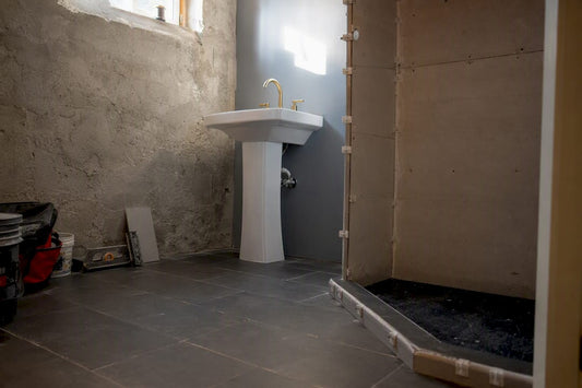 Renovated basement bathroom corner with tile and sink