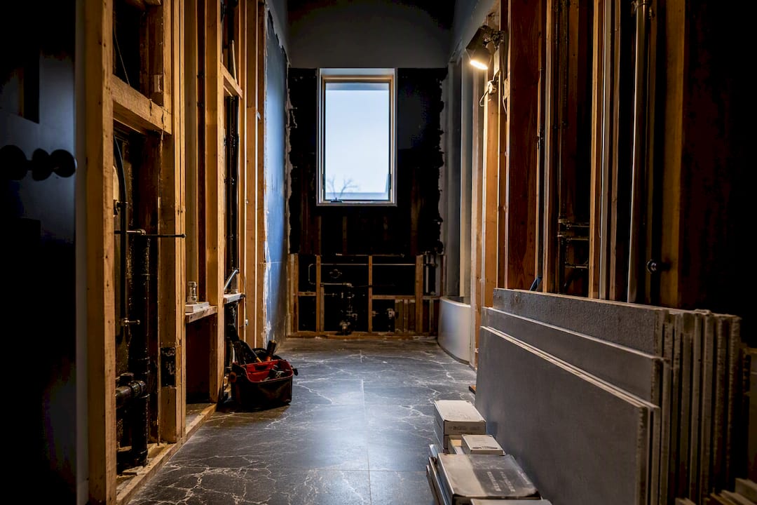 Bathroom gut renovation with exposed wall framing